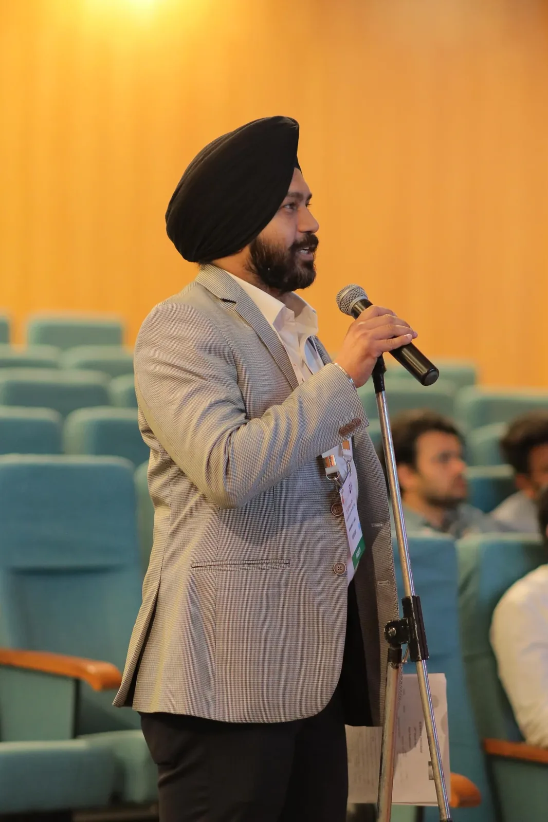 Dr. Mansimrat speaking at a surgical conference